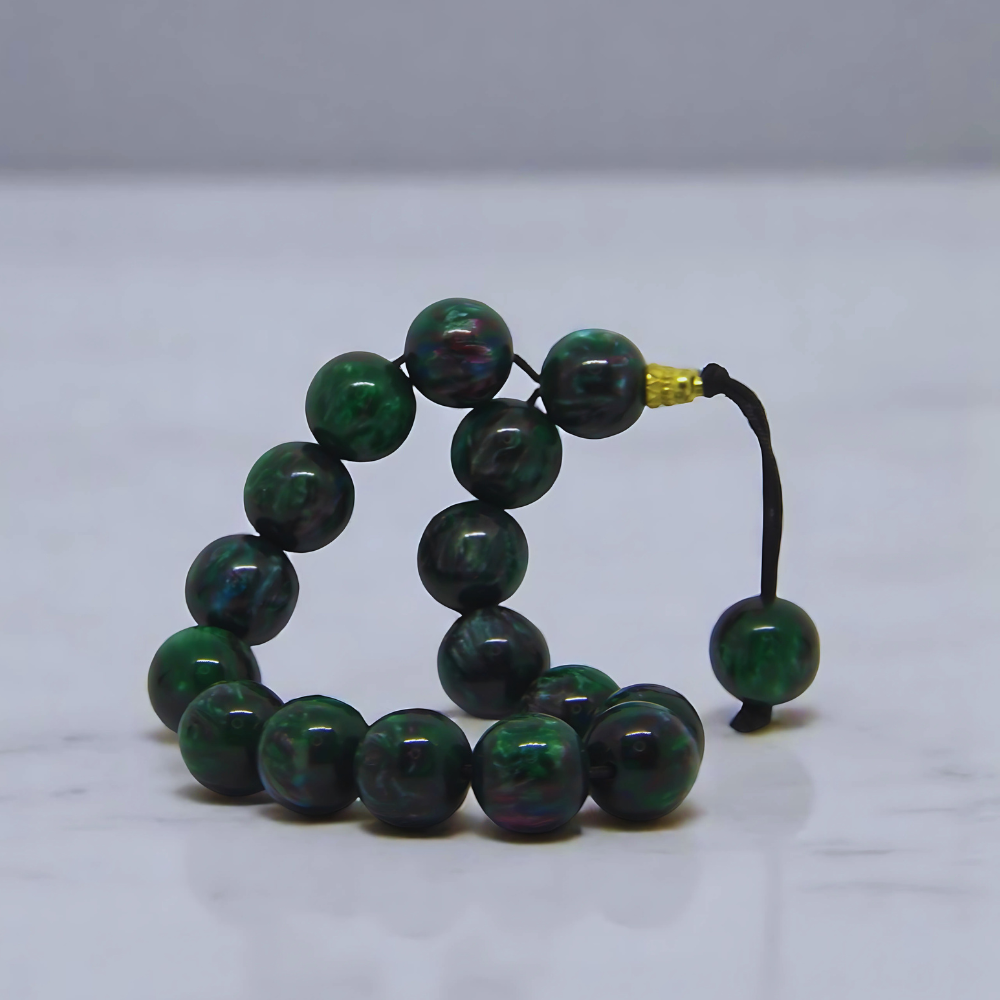 handmade black tasbih prayer beads on a white background